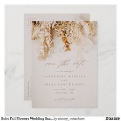 a white wedding card with gold foil flowers