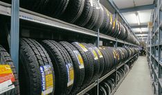 rows of tires on shelves in a warehouse