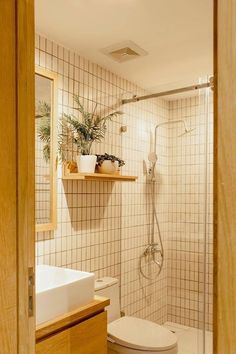 a bathroom with a toilet, sink and shower