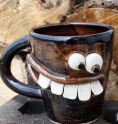 a coffee cup with googly eyes and teeth