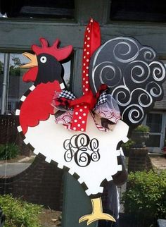 a sign with a rooster on it in front of a building