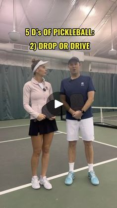 a man and woman standing on top of a tennis court holding racquets