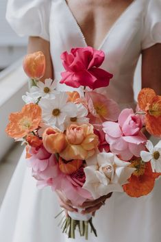 a bride holding a bouquet of flowers in her hands