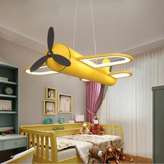 a yellow airplane hanging from the ceiling in a child's room