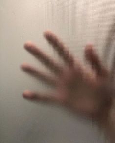 a person's hand is seen through a screen