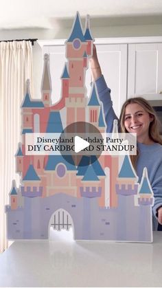 a woman standing in front of a castle with the words disneyland that says diy cardbe standup