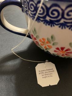 a tea cup with a tag attached to it