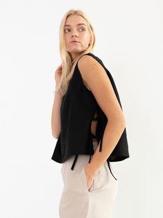 "AVERY is a linen tank top with side ties. DETAILS - Sleeveless design - Crew Neck - Side Ties - Straight cut - 100% lightweight European linen fabric - Cut and sewn to order just for you in our studio COLOR - Black, you can also choose other colors above - Fabric samples are available here https://www.etsy.com/listing/586569696/linen-fabric-samples SIZING & FIT - Fits true to size - Length is approximately 19 inches / 48 cm - Bust is approximately 19 inches / 48 cm - Measurements taken from Linen Sleeveless Top, Linen Wedding Dress, Linen Crop Top, Linen Tank Top, Linen Tank, Square Neck Top, Tie Top, Black Linen, Linen Top