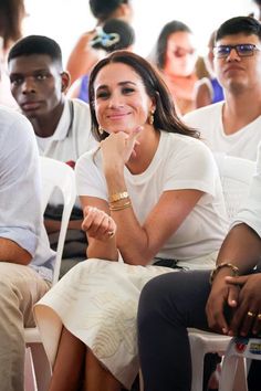 a woman sitting in front of a group of people