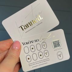 a person holding up a white business card