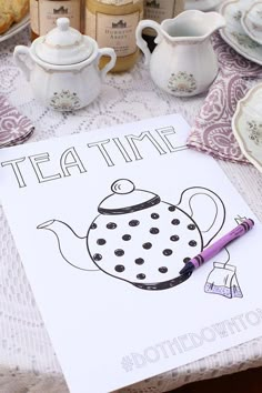 a tea time poster on a table next to cups and saucers