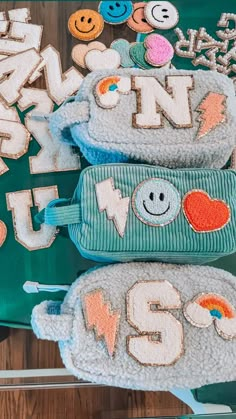 some cookies that are sitting on top of a green tray with letters and smiley faces