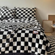 a black and white checkered comforter on a bed