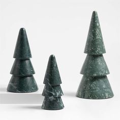 three green marble christmas trees on a white background