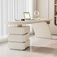 a white desk with a laptop on it