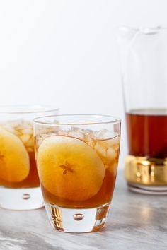 three glasses filled with liquid sitting on top of a table