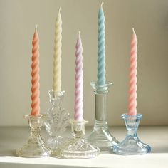 four candles are lined up next to each other