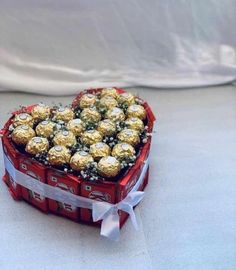 a heart shaped box filled with lots of chocolates