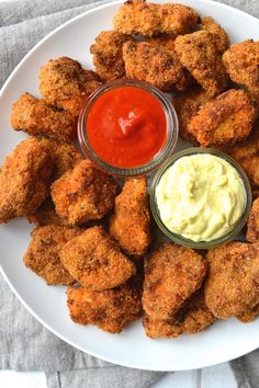 a white plate topped with chicken nuggets and ketchup