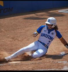 a baseball player sliding into home plate during a game