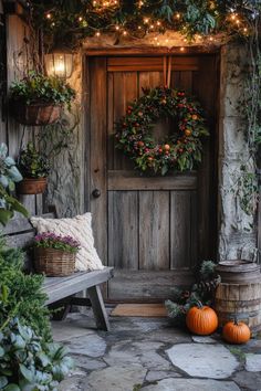 a wooden door surrounded by greenery and pumpkins