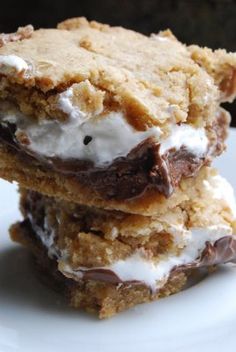 three pieces of cake sitting on top of a blue and white plate with almonds