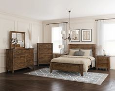 a bedroom scene with focus on the bed, dresser and mirror in the room's center