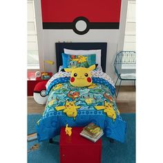 a bed room with a pokemon comforter and pillows