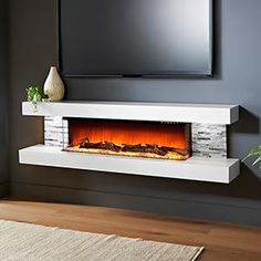 an electric fireplace in a living room with a flat screen tv on the wall