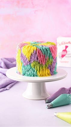 there is a cake that has been decorated with multicolored icing