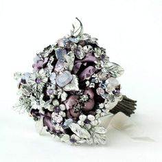 a bridal bouquet with purple and silver flowers