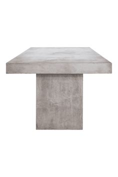 a concrete table sitting on top of a white floor