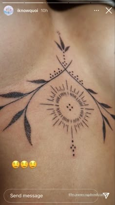 the back of a woman's chest with an arrow and leaves tattoo on it