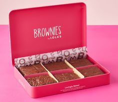 four pieces of brownies in a pink box