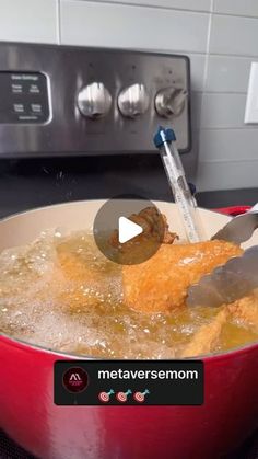 a red pan filled with food on top of a stove