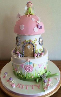 a birthday cake with a fairy house on top