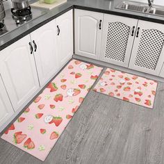 a kitchen area with two rugs on the floor