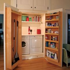 an open door to a washer and dryer in a room with wooden floors