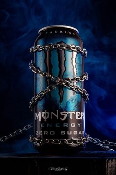 a can of monster energy drink with chains on the chain around it's neck