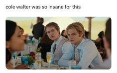 three men sitting at a table talking to each other