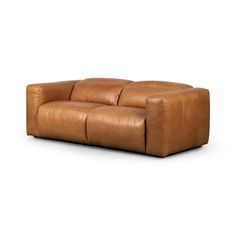 a brown leather couch sitting on top of a white floor