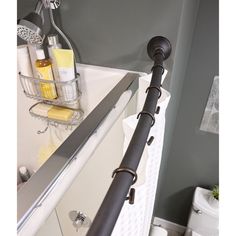 a bathroom with a sink, mirror and toiletries on the shelf above the bathtub