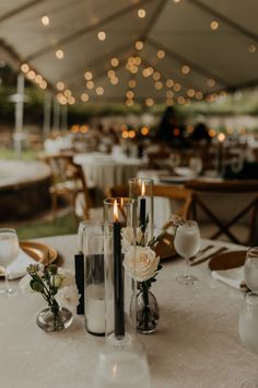 the table is set with candles and flowers