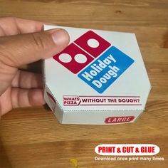 a hand is pointing at a box that has two dices on it and the word, holiday dough