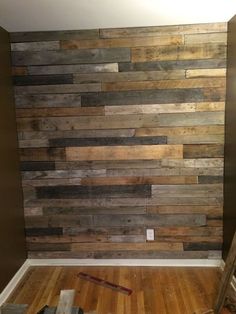 a bathroom with wood planks on the wall