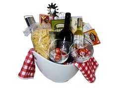 a white bowl filled with wine, pasta and other items on a red checkered table cloth