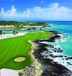 an aerial view of a golf course near the ocean