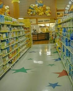 an aisle in a grocery store filled with lots of food and drinks on shelves next to each other