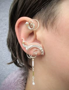 ORDERS PLACED AFTER DECEMBER 1, MAY ARRIVE AFTER CHRISTMAS OR NEW YEAR EVE due to the postal services being overwhelmed this time of year. Average delivery terms USA, France, Ireland - 3-4 weeks Australia, Canada - 4-6 weeks Netherlands, Spain - 2-3 weeks A pair of ear cuffs made of silver plated copper wire, white and golden glass beads with delicate danglings. The length of the dangles is 1 1/3" (3.4 cm).  These earrings are covered with metal protecting lacquer. No piercing needed, they are w Unique Adjustable Pierced Ear Climbers, Adjustable Unique Style Ear Climbers, Pierced Metal Ear Cuff With Unique Style, Pierced Metal Ear Cuff As A Gift, Pierced Dangle Ear Cuff For Wedding, Unique Gold Sterling Silver Ear Cuff, Metal Ear Cuff For Pierced Ears As Gift, Adjustable White Ear Cuff Single Earring, Adjustable White Ear Cuff