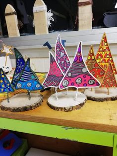 colorful wooden sailboats sitting on top of a table